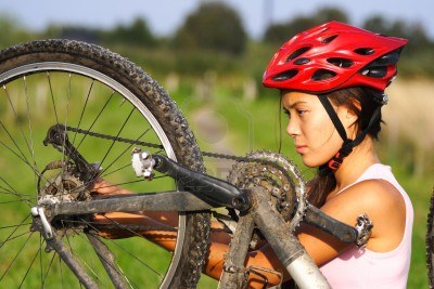 Woman Repairing Bicycle