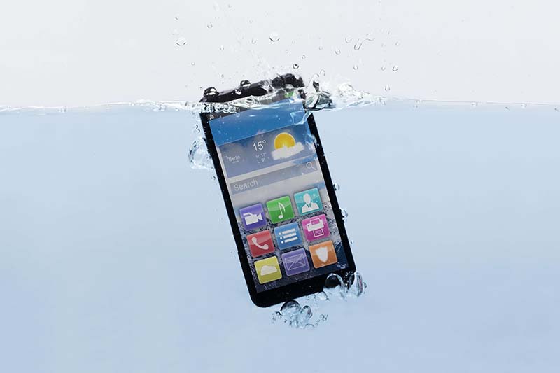 Image of phone with colourful icons submerged in water